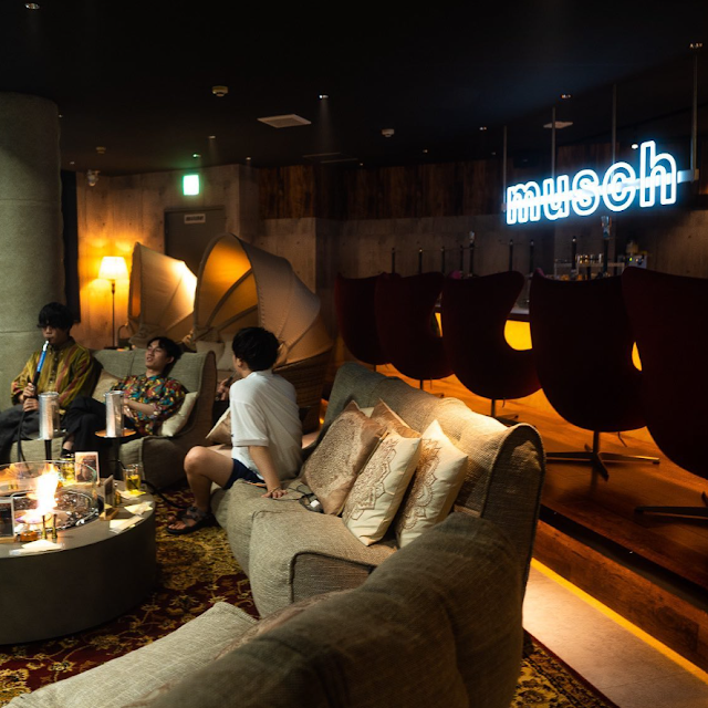 Cosy hookah lounge atmosphere at Mush Osaka with shisha pipes and low seating