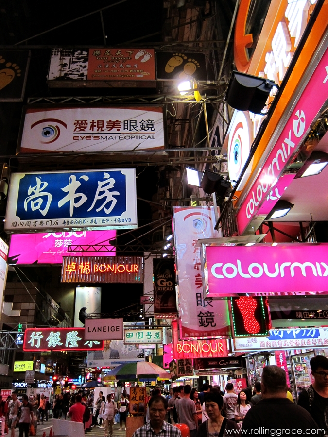 Dense urban streetscape in Mong Kok with signage and residential buildings