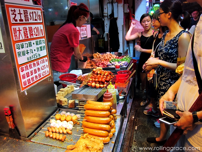 Street food stall in Mong Kok serving fish balls and skewered snacks at night