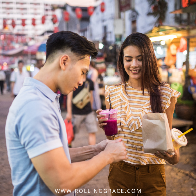 Couple in casual outfits at a Malaysian street market, way to dress in Malaysia for tourists