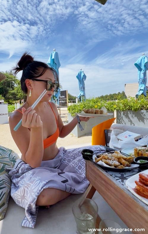 Outdoor seating at +Twelve Sentosa beach club with ocean views and relaxed daytime atmosphere in Singapore