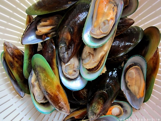 Greenshell mussels in half shells prepared and ready for cooking in Thai-style broth
