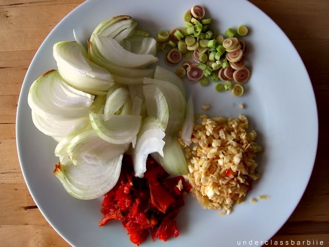 Thai cooking aromatics including lemongrass, garlic, chillies, and kaffir lime leaves prepared for broth