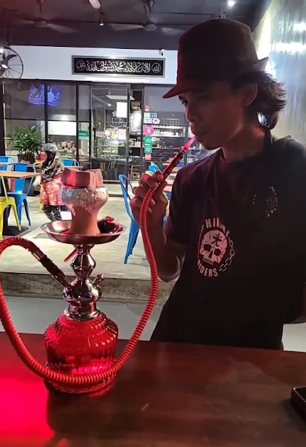 6 Best Shisha in TTDI: Top Hookah at Taman Tun Dr Ismail 3 Visitor smoking Shisha at Coffee Cartel TTDI