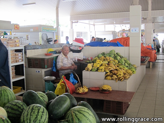 Indoor food hall at Tamu Kianggeh market with fruit stalls in Bandar Seri Begawan