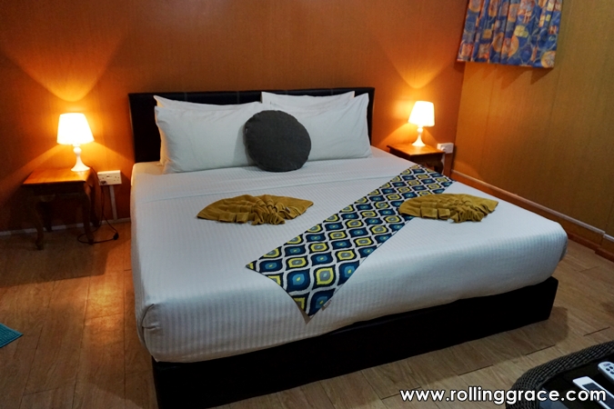 Deluxe Room interior at Seaventures Dive Rig with double bed and seating area, Sabah