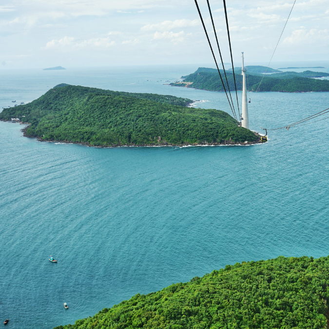 Hon Thom cable car crossing over turquoise water toward Hon Thom island, Phu Quoc