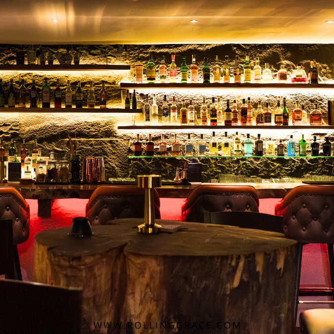 Bar counter at LandOn Kuala Lumpur with house made syrups, glassware and a crafted cocktail setup.