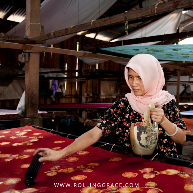 Traditional batik Malaysia artisan applying wax fabric