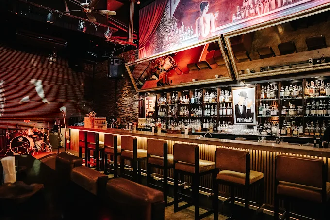 Dimly lit bar interior at Whisgars lounge on Sukhumvit 23 Bangkok Thailand