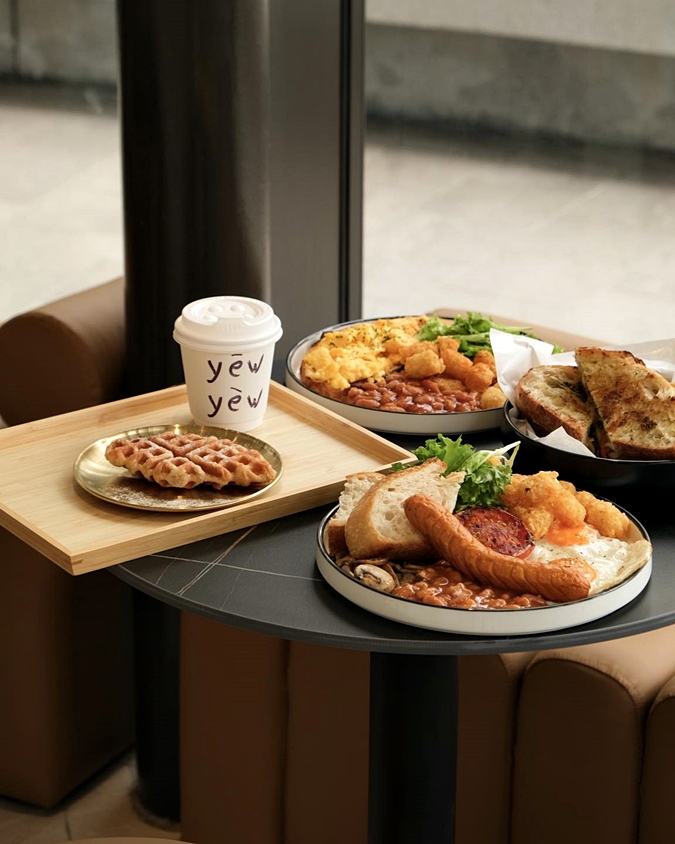 Coffee and breakfast plates served at Yew Yew Coffee in The Gardens Mall
