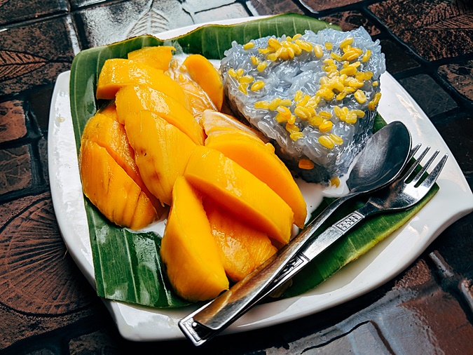 Harum Manis mangoes from Perlis displayed on a wooden table