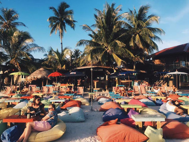 Beachfront crowd relaxing at Kalut Beach Bar N Cafe Langkawi during daytime