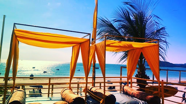 Beachfront seating at Yellow Beach Cafe Langkawi with sunset views and cabana-style decor
