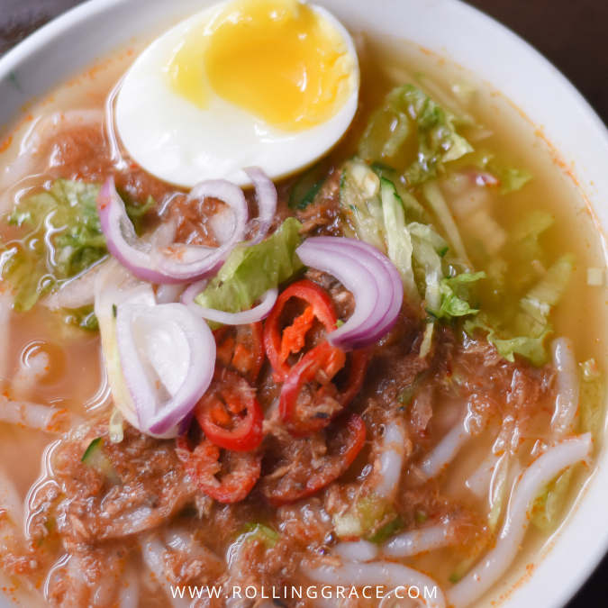 Laksa Kedah served with rice noodles, fish-based gravy, and herbs