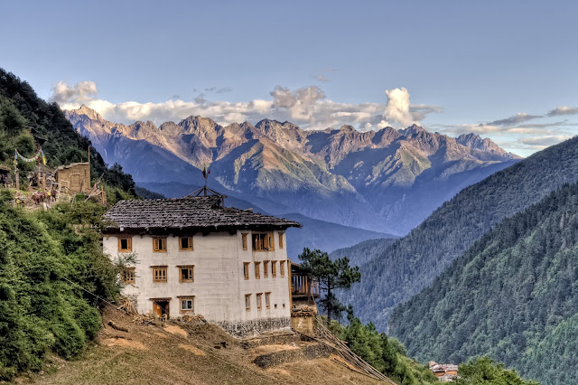 Rural house near Shangri-La with Meili Snow Mountains in the background