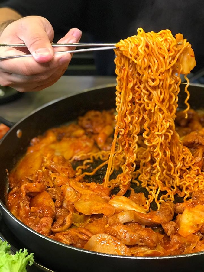 Mr. Dakgalbi halal Korean restaurant in Kuala Lumpur cooking dakgalbi at the table