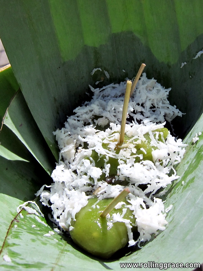 Klepon Bali — green pandan glutinous rice balls filled with palm sugar, wrapped in banana leaf with coconut rice