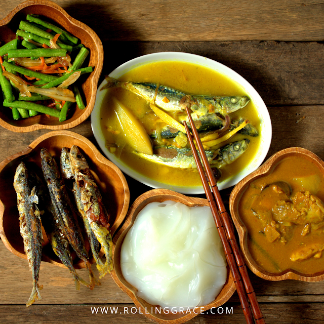 Ambuyat Brunei national dish in wooden bowls with fish curry pinasakan and side dishes