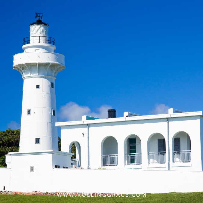 White lighthouse at Eluanbi Park on the southernmost tip of Taiwan under blue sky