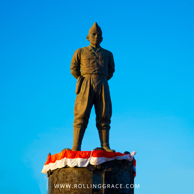 Bronze statue of Colonel I Gusti Ngurah Rai standing tall against a clear blue sky in Bali, Indonesia