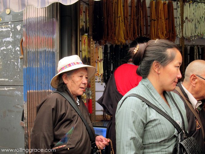 Two Tibetan women in traditional dress chatting on a street in the Tibetan Quarter, Chengdu