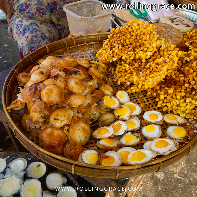 Assorted A Kyaw Sone fritters in a basket with chilli dipping sauce, Myanmar street food