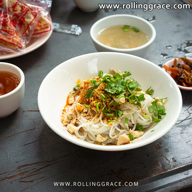 Bowl of Shan Khao Swe noodle soup with chicken and herbs, Shan State Myanmar