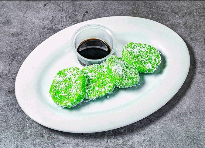 Green onde-onde kuih muih on a white plate at Warung Pak Din Palm Grove Klang