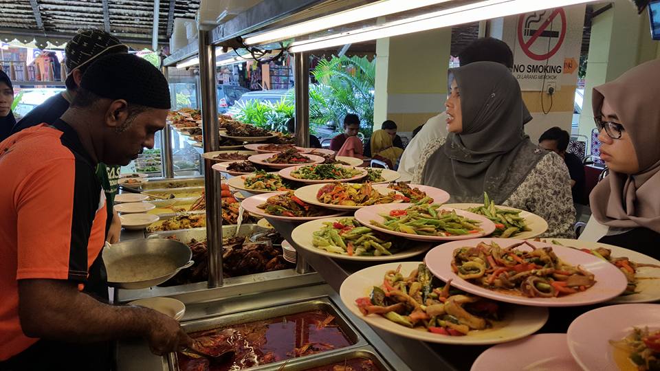A long row of various asam pedas claypots and side dishes at Asam Pedas Selera Kampung