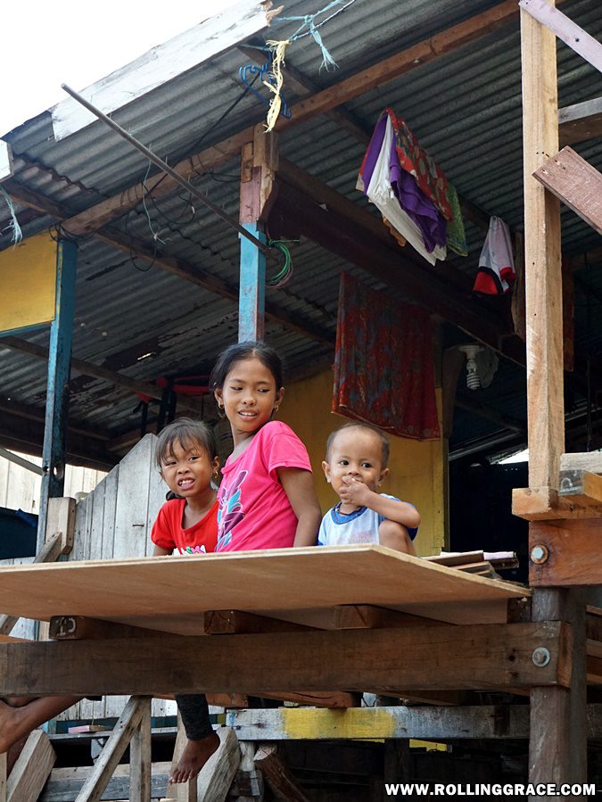Bajau Laut children inside a wooden stilt house at Pulau Mabul Sabah Malaysia
