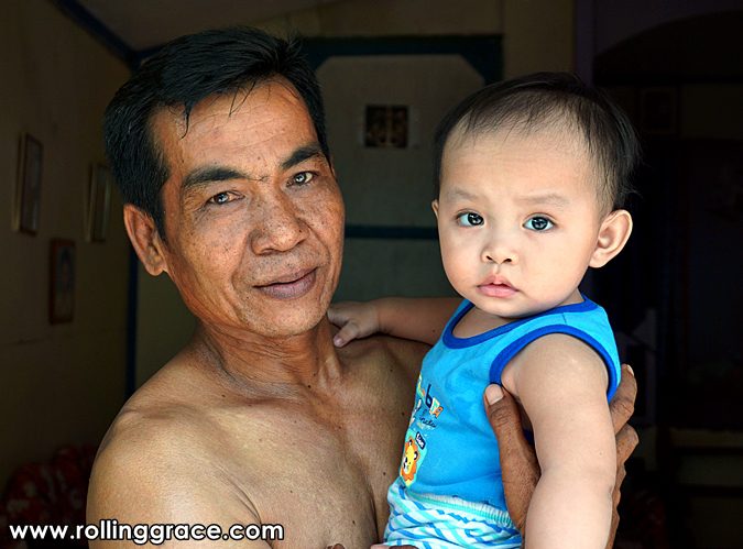 Bajau Laut father holding baby at Pulau Mabul Sabah Malaysia