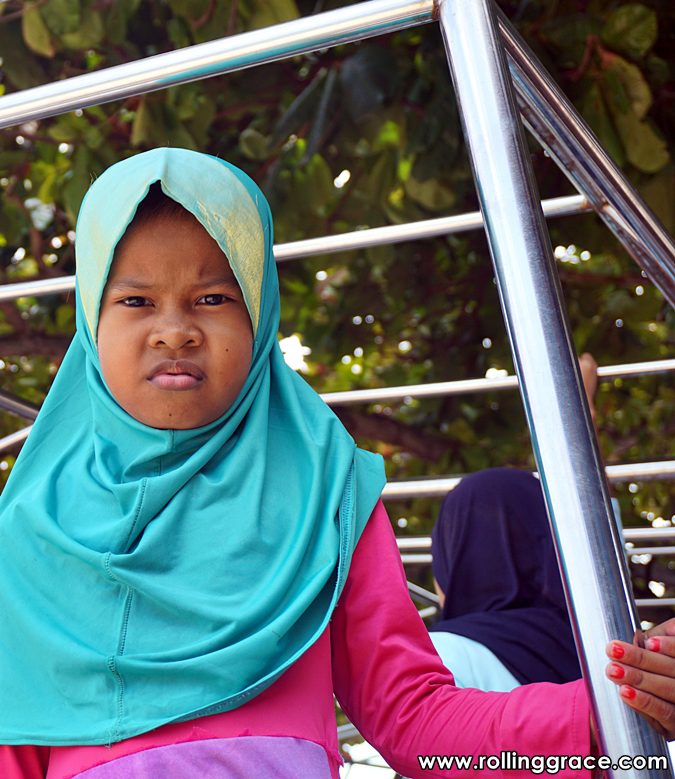 Young Bajau Laut girl wearing teal hijab at Pulau Mabul Sabah Malaysia