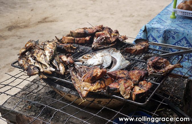 Freshly caught fish grilling over charcoal at Kampung Mabul Pulau Mabul Sabah