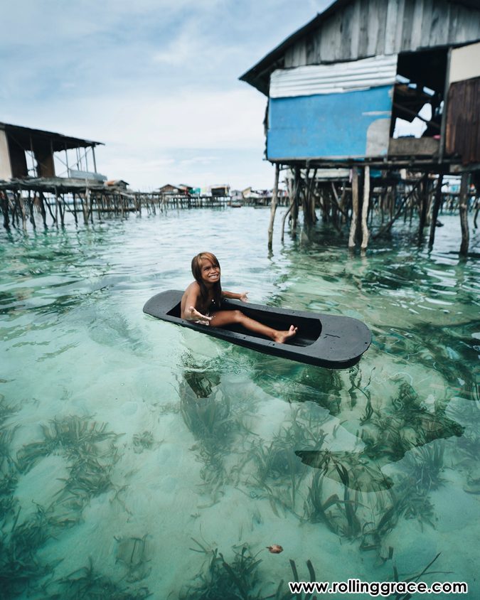 10 Best Things to Do in Mabul Island, Sabah You Must Try 4 Child on a wooden board in the shallow waters of the Bajau Laut stilt village, Mabul Island