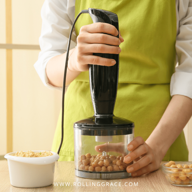 Creamy and Easy Hummus Recipe at Home in 15 Minutes 7 Blending cooked chickpeas with an immersion blender to make homemade hummus from
