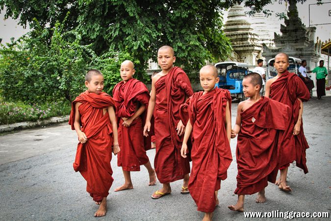 Young Buddhist novice monks walking on a street in Yangon Myanmar