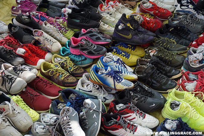 Piles of secondhand shoes for sale at a bundle stall in the flea market section of Nat Pokok Getah, Perlis