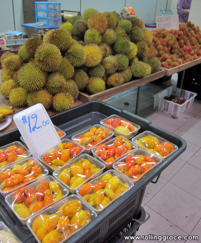 Whole durians displayed on trays with price tags at the fruit section of Gadong Night Market in Brunei