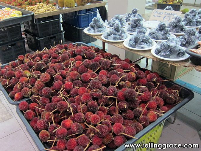 Trays of fresh red pulasan for sale at the fruit section of Gadong Night Market in Brunei