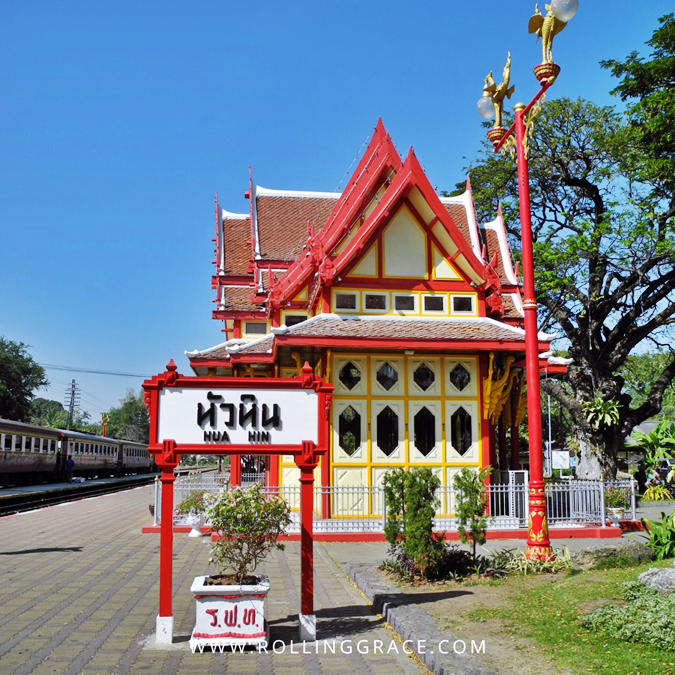 The red and cream wooden Hua Hin Railway Station with Thai signage, one of the oldest in Thailand