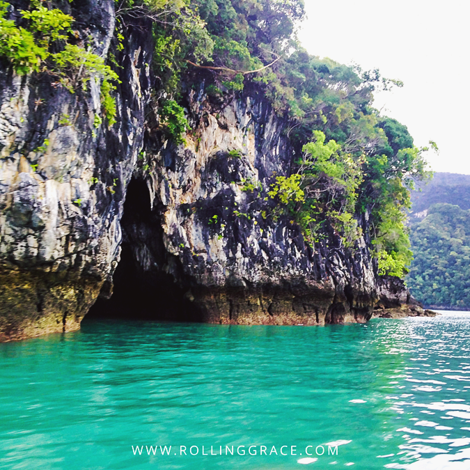 Limestone karsts rising from turquoise water during an island hopping boat tour in Langkawi