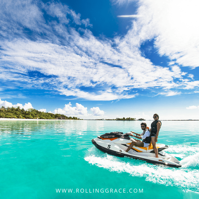 Couple on a jet ski heading towards limestone islands during an island hopping tour in Langkawi