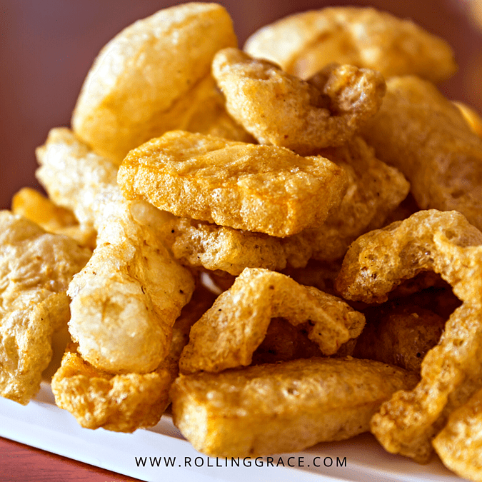 Pile of golden kaeb moo, deep-fried crispy pork rinds sold at Chiang Mai street food stalls