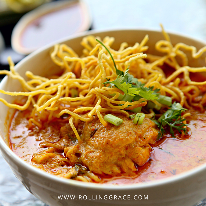 Bowl of khao soi, Chiang Mai's signature coconut curry noodle soup topped with crispy fried egg noodles
