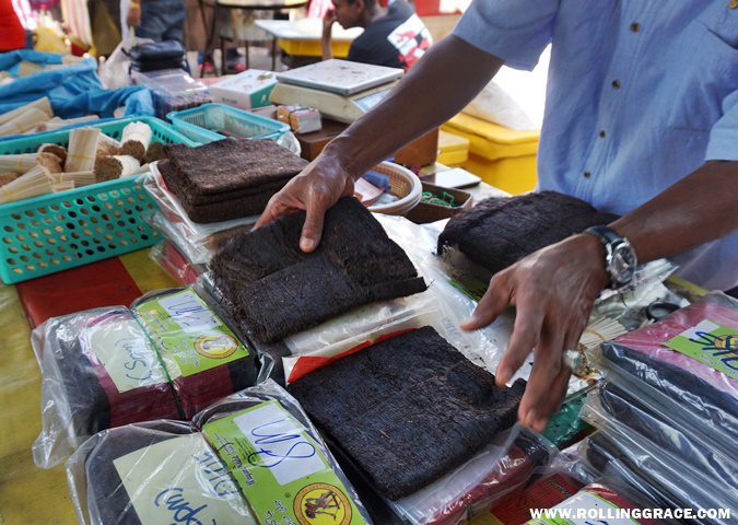 A vendor displaying locally produced tobacco sheets at Nat Pokok Getah morning market in Arau, Perlis