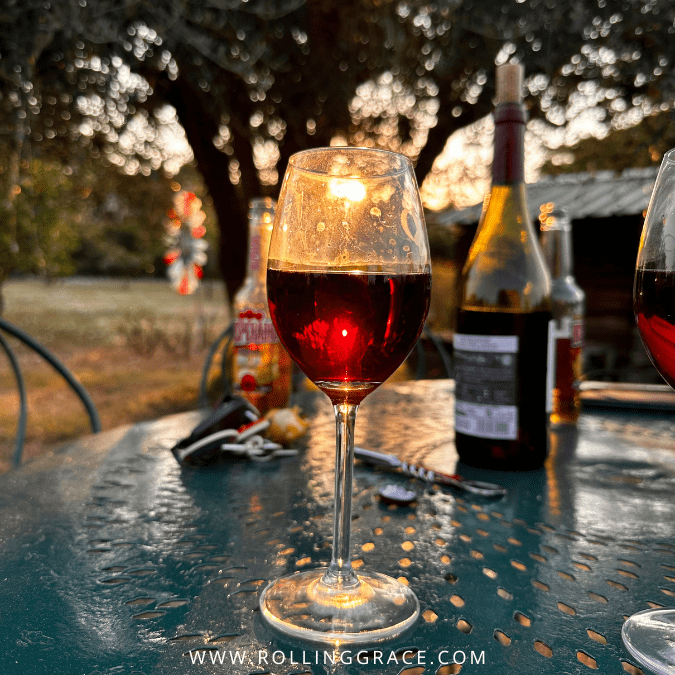 A glass of red wine at Monsoon Valley Vineyard with views across the hills near Hua Hin
