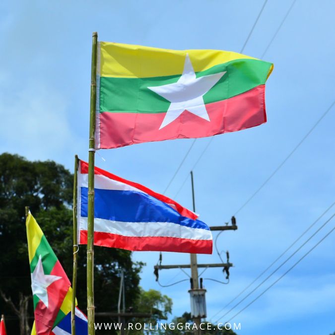 Myanmar and Thailand flags displayed on street poles in Southeast Asia