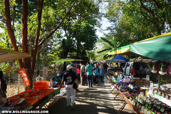 Vendors and shoppers beneath the rubber tree canopy at Nat Pokok Getah morning market in Arau, Perlis