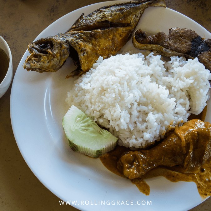 Plate of nasi ulam with steamed rice, grilled fish and sambal at Restoran Nasi Ulam Cikgu Kampung Kraftangan Kota Bharu
